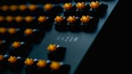 Mechanical keyboard with exposed yellow switches (Image via Volodymyr Kozhevnikov/Unsplash/Razer)
